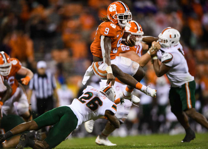 Clemson Tigers running back Travis Etienne (9) leaps over Miami Hurricanes safety Gurvan Hall, Jr. (26) during the third quarter at Memorial Stadium.